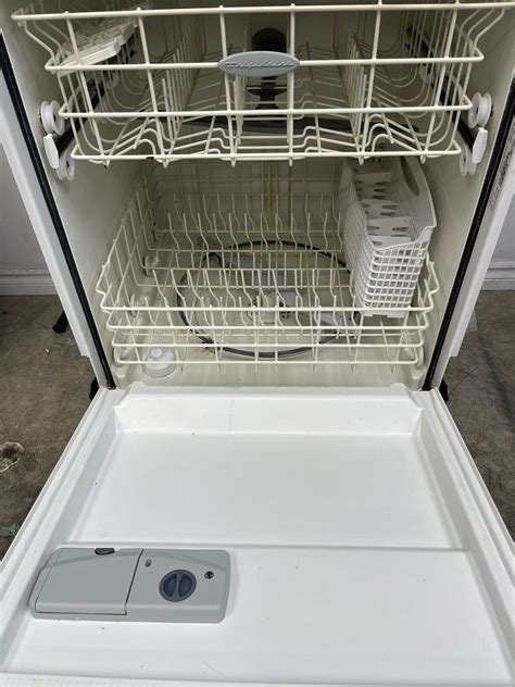 Used frigidaire dishwasher - 1. Move the bottom rack out of the dishwasher to uncover the filter. Open your dishwasher and pull the bottom dish rack out to uncover the back of the machine. You should see 3 things: a spray arm, a cylindrical filter, and a coarse mesh filter. The cylindrical and coarse mesh filters are the parts of the dishwasher you’ll need to clean.